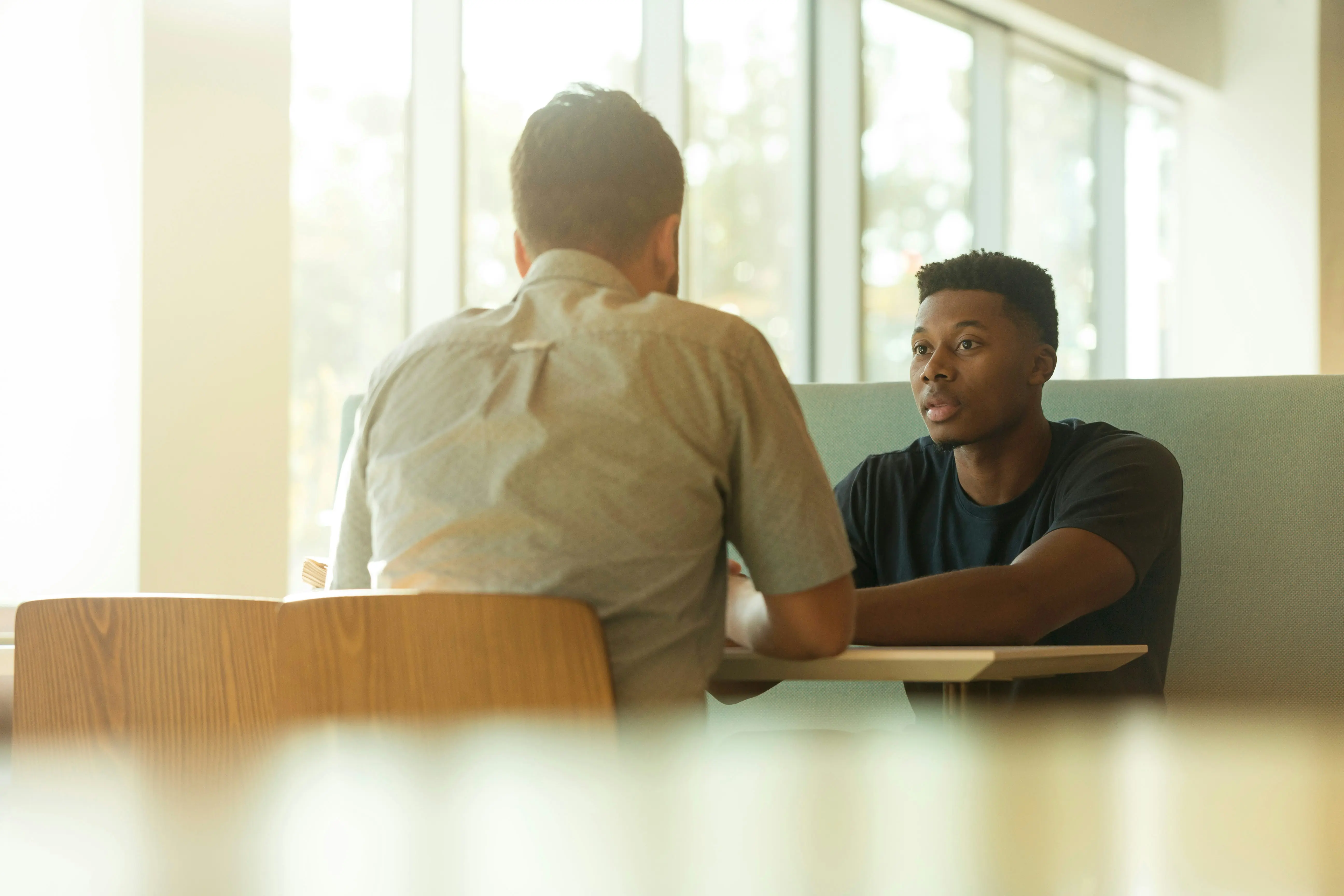 Two professionals in a one-on-one mentoring conversation